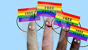 Fingers of one hand, of various ethnic groups manifest with rainbow flags, symbol for humanitarian and sexual rights