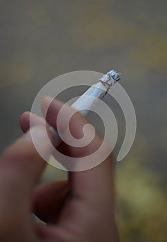 Fingers with smoking cigarette