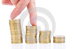 Fingers step on a stack of coins. Business growth chart