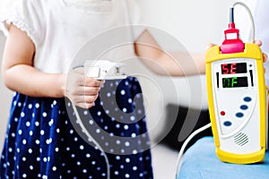 Fingertip Pulse Oximeter on finger of little baby child photo