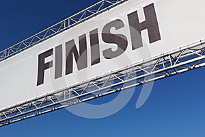 A finish line banner isolated across a clear blue sky