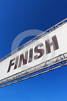 A finish line banner isolated across a clear blue sky