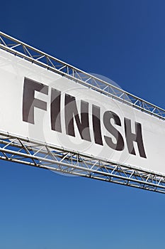 A finish line banner isolated across a clear blue sky
