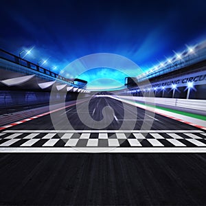 Finish line on the racetrack in motion blur with stadium and spotlights