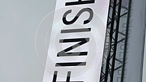 Finish line. Vertical video. Word Finish on white banner. Finishing arch