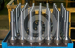 Finished metal shafts with threaded with CNC stand on metal table