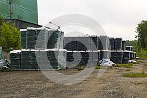 Finished products of clean bottles are packed in pallets. Racks with bottles are in  abandoned area near  glass factory near