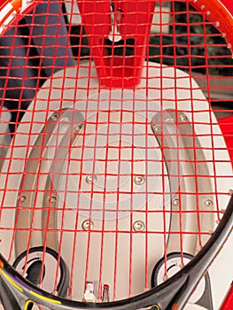 Finished Tennis racquet freshly strung on a electronic stringing machine photo