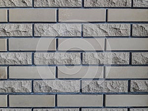 Finishing bricks for walls. Smooth and chipped. Gray background. Exterior