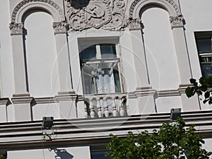Finishing of the facade of the residential building of the Soviet period of construction columns, sickle and hammer.