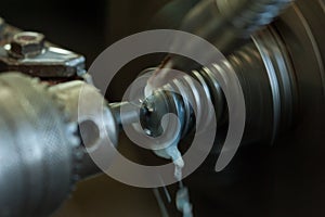 Finishing metal working internal steel surface on lathe grinder. Metalworking industry