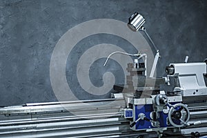 Finishing metal working on lathe grinder machine with sparks, machine tool in metal factory with drilling cnc machines