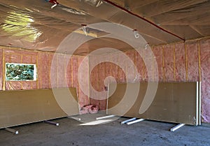 Finishing a newly constructed garage with insulation and sheet rocking photo