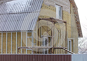 Finishing with siding and insulation of the walls of the house.