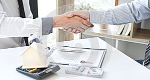 Finishing to successful deal of real estate, Broker and client shaking hands after signing contract approved application form,