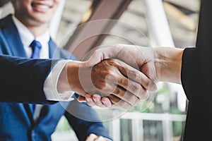 Finishing up a meeting, handshake of two happy business people after contract agreement to become a partner, collaborative