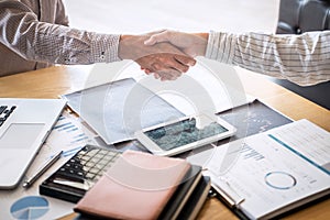 Finishing up a meeting, handshake of two happy business people after contract agreement to become a partner, collaborative