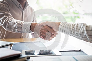 Finishing up a meeting, handshake of two happy business people after contract agreement to become a partner, collaborative
