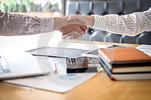 Finishing up a meeting, handshake of two happy business people after contract agreement to become a partner, collaborative