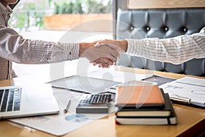 Finishing up a meeting, handshake of two happy business people after contract agreement to become a partner, collaborative