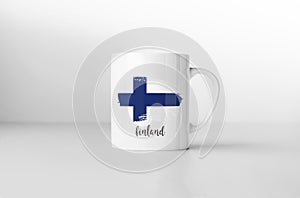 Finland flag on white coffee mug.