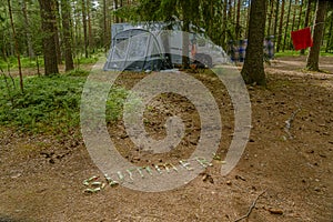 Finland Porvo. June 28, 2021 the word SUMMER is laid out on the ground with watermelon peels. In the background a caravan car with photo