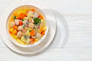 finnish sausage soup with vegetables in white bowl