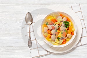 finnish sausage soup with vegetables in white bowl