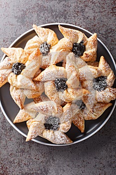 Finnish star-shaped joulutorttu christmas cake with dried marmalade close-up in a plate. Vertical top view