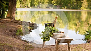 Finnish summer landscape and sauna objects on bench by lake.