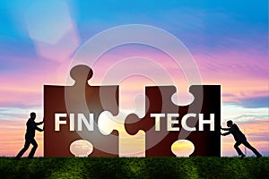 The fintech financial technology concept with puzzle pieces photo