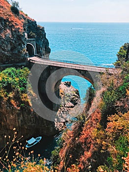 Fiordo di Furore picturesque landscape view on arch bridge with narrow road and and Tyrrhenian sea horizon photo