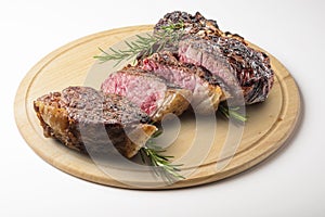 Fiorentina T-bone steak cut on round wooden chopping board photo