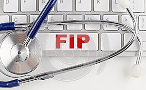FIP text on keyboard with stethoscope , medical concept