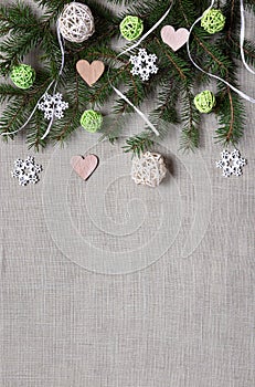 Fir branch, balls, hearts and snowflakes on gray