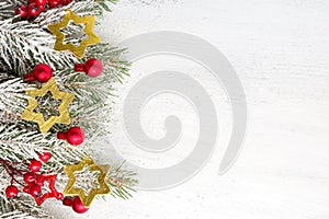 Fir branch with Christmas decorations on old wooden shabby background with copy space for tex