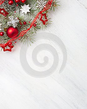 Fir branch with Christmas decorations on old wooden shabby background with copy space for text