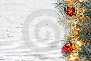 Fir branch with Christmas decorations on old wooden shabby background with copy space for text