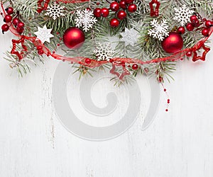 Fir branch with Christmas decorations on old wooden shabby background with copy space for text