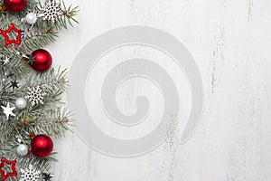 Fir branch with Christmas decorations on old wooden shabby background with copy space for text