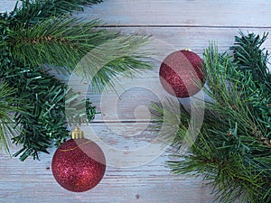 Fir branch and red ball on wooden table
