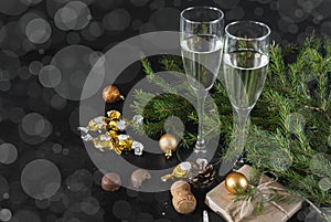 Fir branches, glasses of sparkling wine, chocolates with Golden wrappers, gift box, balloons, champagne, Christmas decor