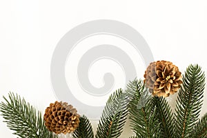 Fir branches with pine cones and gifts in craft paper and scourge on a white background for text for the holiday christmas or new