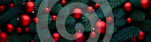 Fir branches and red balls and baubles green needle abstract background.