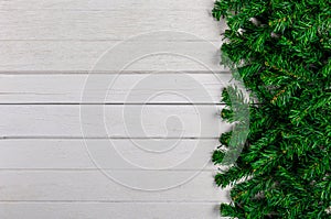 Fir branches on white wooden board