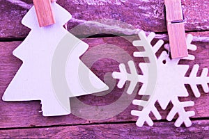 Fir tree ands snowflake toys on wooden background
