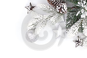 Fir tree branch with christmas decor covered with snow