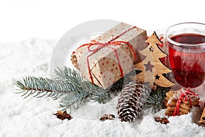 Fir tree branch, decorations, gingerbread cookies and gift boxes on a winter snow background with copy space