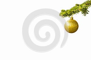 Fir tree branch with a golden glitter ball on white background. Christmastime. Christmas postcard