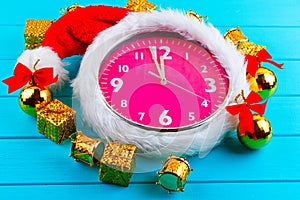 Fir tree with christmas decorations, alarm clock and gift